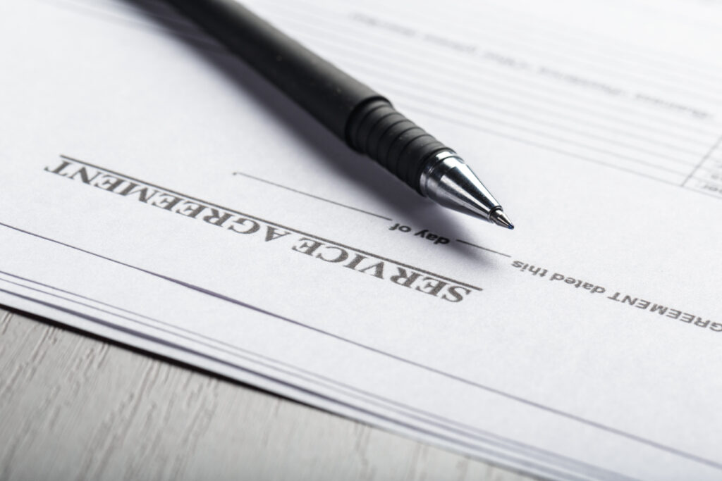 service agreement document with a pen on a wooden table